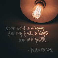 a light that is on top of a wall with a bible verse written underneath it