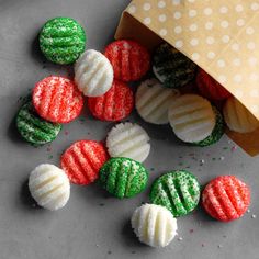 several decorated cookies sitting on top of a table next to a brown paper bag with polka dots