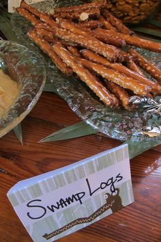 there are many different types of food on the table, including pretzels and other snacks