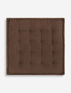 a brown square cushion on a white background