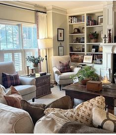 a living room filled with furniture and a fire place in the middle of a room