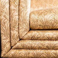 an upholstered couch is shown in this close - up photo, with the fabric folded back