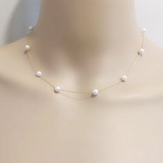 Item No: NK584 Item:sterling silver pearl necklace Pearl shape:round shape Pearl size:5-6mm Pearl color: white Pearl skin: with little flaws Pearl luster: good Pearl quality: AA the space between two pearl: 3.5cm Chain length: 16inch,18inch,20inch,22inch,24inch,26inch,27.5inch Chain: sterling silver with white gold plated, or yellow gold plated Packing: beautiful giftbox, ready for gift giving Please contact Lisha if any more questions. Illusion Pearl Necklace, White Minimalist Single Strand Chain Necklace, Minimalist White Single Strand Chain Necklace, Minimalist White Chain Necklace For Party, White Pearl Necklace With Delicate Chain For Party, Delicate White Pearl Chain Necklace, White Pearl Necklace With Delicate Chain For Formal Occasions, Dainty White Chain Necklace With Pearl Charm, Delicate White Pearl Drop Chain Necklace