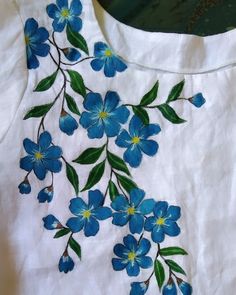 a white shirt with blue flowers on it