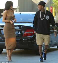 a man and woman walking down the street