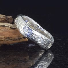 Eye catching 5.6mm wide eight stone rustic wave ring in Sterling Silver by Michael Pavone. This ring is set with eight 3mm flush set Swarovski stones and is a UK size O which is US size 7 1/4 - The depth of the ring ranges around 2.4mm in thickness and there are some very minor natural cast marks on the polished inside edge from the casting process - Full Edinburgh .925 Sterling Silver hallmarking for 2024. Lovely looking ring with lots of light catching sparkle in the stones. Wave Ring, Swarovski Stones, Rings Statement, Edinburgh, Halloween Shopping, Statement Rings, Jewelry Rings, Accessory Gift, Gems