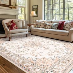 a living room filled with furniture and a rug on top of a hard wood floor