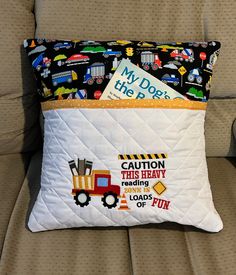 a pillow that is on the back of a couch with a construction themed cover over it