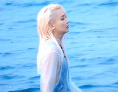 the blonde haired woman is standing in the water