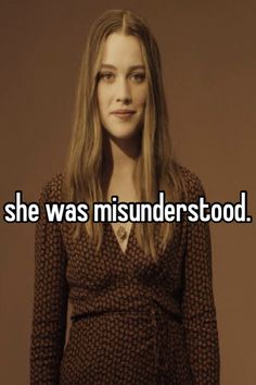 a woman standing in front of a brown background with the words she was misinderstod