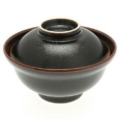 a black and brown bowl with an empty lid