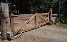 a wooden gate with an automatic water pump attached to it