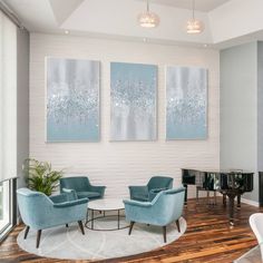 a living room with two blue chairs and a piano