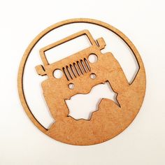 a wooden cutout of a jeep in the shape of a circle on a white background