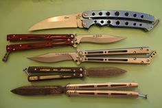 several different types of knives on a table