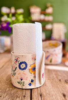 two rolls of toilet paper sitting on top of a wooden table