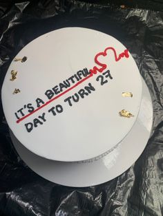 a white cake with red writing on it that says it's a beautiful day to turn 21