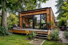 a small wooden house sitting on top of a lush green field