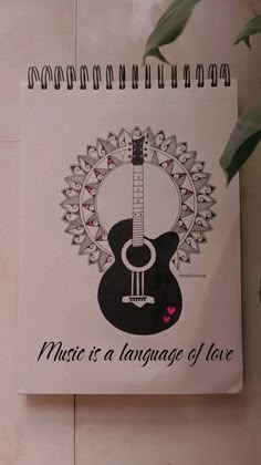 a notepad with a guitar on it and the words music is a language of love