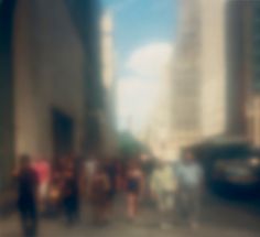 blurry photograph of people walking down the street