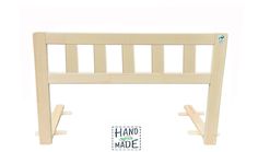 the wooden headboard frame is made out of wood and has two hooks on each side