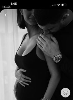 a pregnant woman is holding her husband's hand