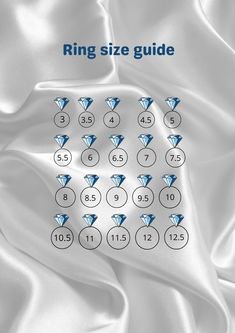 the ring size guide is displayed on a white satin background with blue diamonds in it