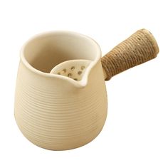 a cream colored ceramic mortar and pestle holder with a wooden handle on an isolated white background