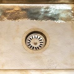 a close up of a sink with a drain running through it's center hole