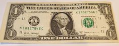 an american one dollar bill is displayed on a white surface