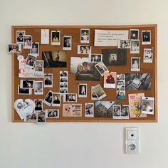 a cork board with pictures and magnets on it