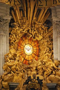 an elaborately decorated altar with statues and a stained glass window