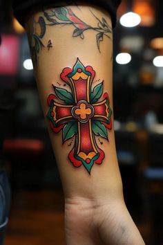 a person with a cross tattoo on their arm