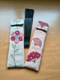 two pieces of fabric sitting on top of a wooden table