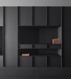 a black book shelf with books on it