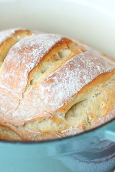 a loaf of bread sitting in a blue bowl