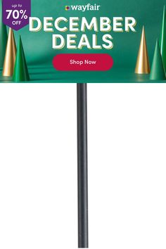 a green sign that says wayfair december specials on it and gold cones in the background