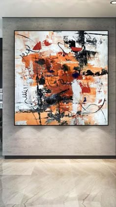 an abstract painting hangs on the wall in a modern living room with white and orange accents