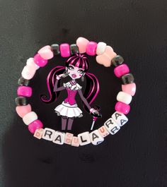 This is a Draculaure themed Kandi Bracelet. This is perfect for fans of our favorite pink vampire and vegan. Personalized Pink Novelty Charm Bracelet, Customized Pink Novelty Jewelry, Personalized Pink Novelty Bracelets, Pink Novelty Wristband For Gift, Themed Pink Bracelets For Birthday, Pink Themed Birthday Bracelets, Pink Personalized Novelty Stretch Bracelet, Personalized Pink Novelty Stretch Bracelet, Adjustable Pink Themed Charm Bracelet