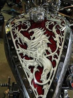 the motorcycle is decorated with red and white designs