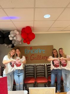 four girls are holding up their shirts in front of the camera