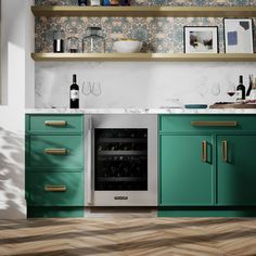 a kitchen with green cabinets and gold trim on the counter tops, wine bottles in an open cabinet