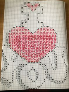 a cross stitch book with an image of a heart and the word love on it