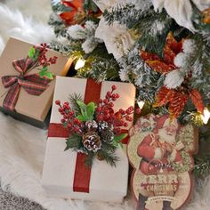 three wrapped presents sitting on top of a white fur covered floor next to a christmas tree