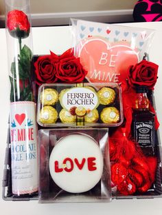 a valentine's day gift basket with chocolates, roses and other items in it