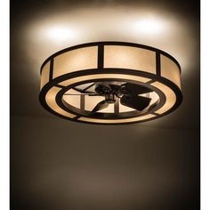 a ceiling light with a fan in the center and two lights on each side of it