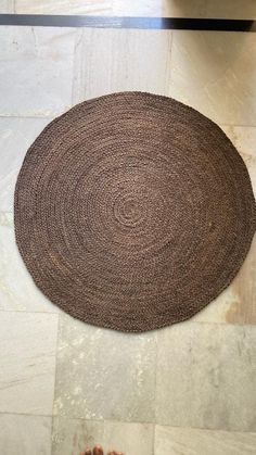 a person standing in front of a rug on the floor