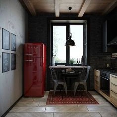 a red refrigerator sitting in the middle of a kitchen next to a dining room table