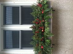 a window box filled with flowers and greenery