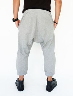 "🚚..ALL ORDERS ARE SHIPPED VIA DHL EXPRESS MAIL Harem-style sweatpants with a cropped profile. Made of stretch cotton-blend jersey, these cropped pants are comfortable to wear and easy to move in. * Pull-on style * Drop-crotch style * Elastic waistband with black drawstring * Side slant pockets * Ribbed ankle cuffs * Cropped length Measurements approximately: Waist: 27\" (68.5 cm) stretching to 48\" (122 cm) Hips: 50\" (127 cm) Outseam: 31\" (79 cm) In Front Rise: 17 1/2\" (44 cm) In Back Rise: Gray Wide Leg Hip Hop Bottoms, Gray Hip Hop Long Pants, Hip Hop Style Straight Leg Stretch Bottoms, Baggy Full-length Bottoms With Hip Pockets, Baggy Full-length Hip Hop Pants, Hip Hop Tapered Leg Pants With Pockets, Hip Hop Baggy Bottoms With Elastic Waistband, Baggy Full-length Sweatpants With Hip Pockets, Gray Baggy Pants With Elastic Waistband